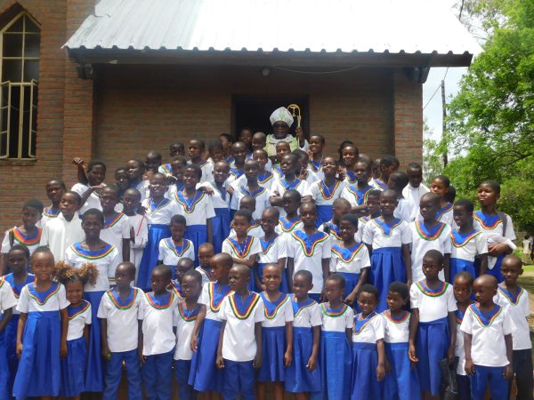 Children posing with Bishop Stima at Koche parish